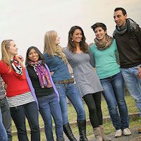 Group of diverse young people standing arm in arm