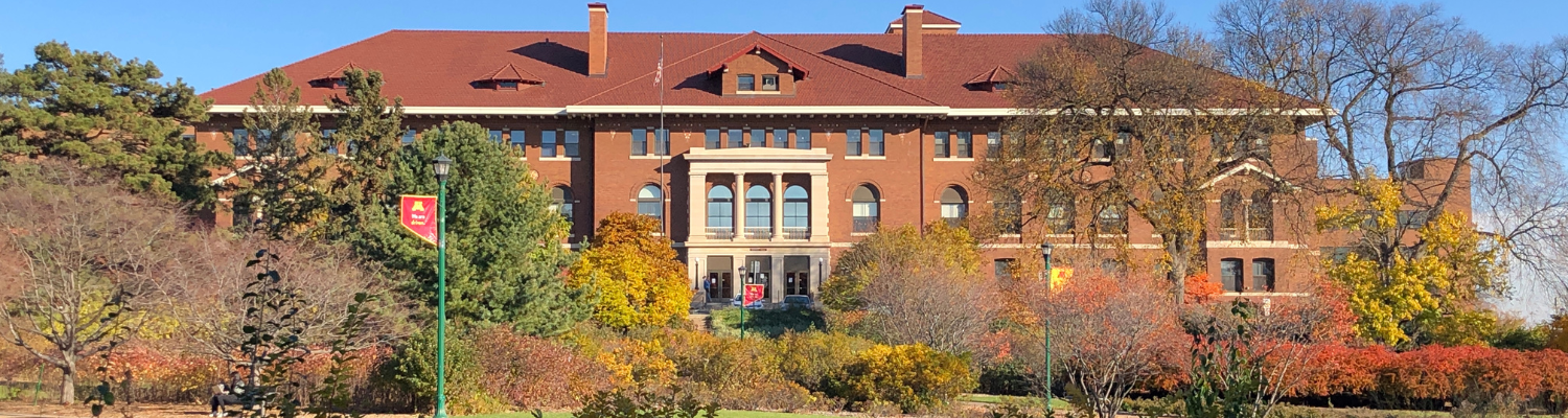 Coffey Hall red brick building on Saint Campus surrounded by fall foliage