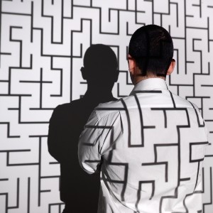 Businessman standing in front of labyrinth 